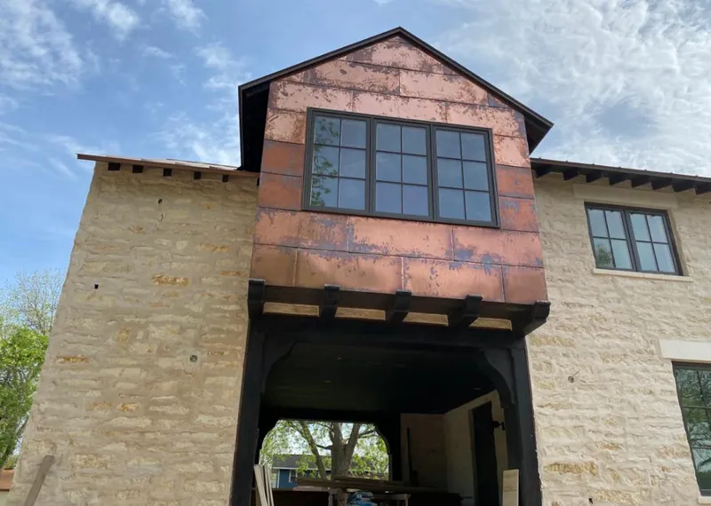 Copper metal panel facade on a stone building for Metal Roof Coating in Cornelius